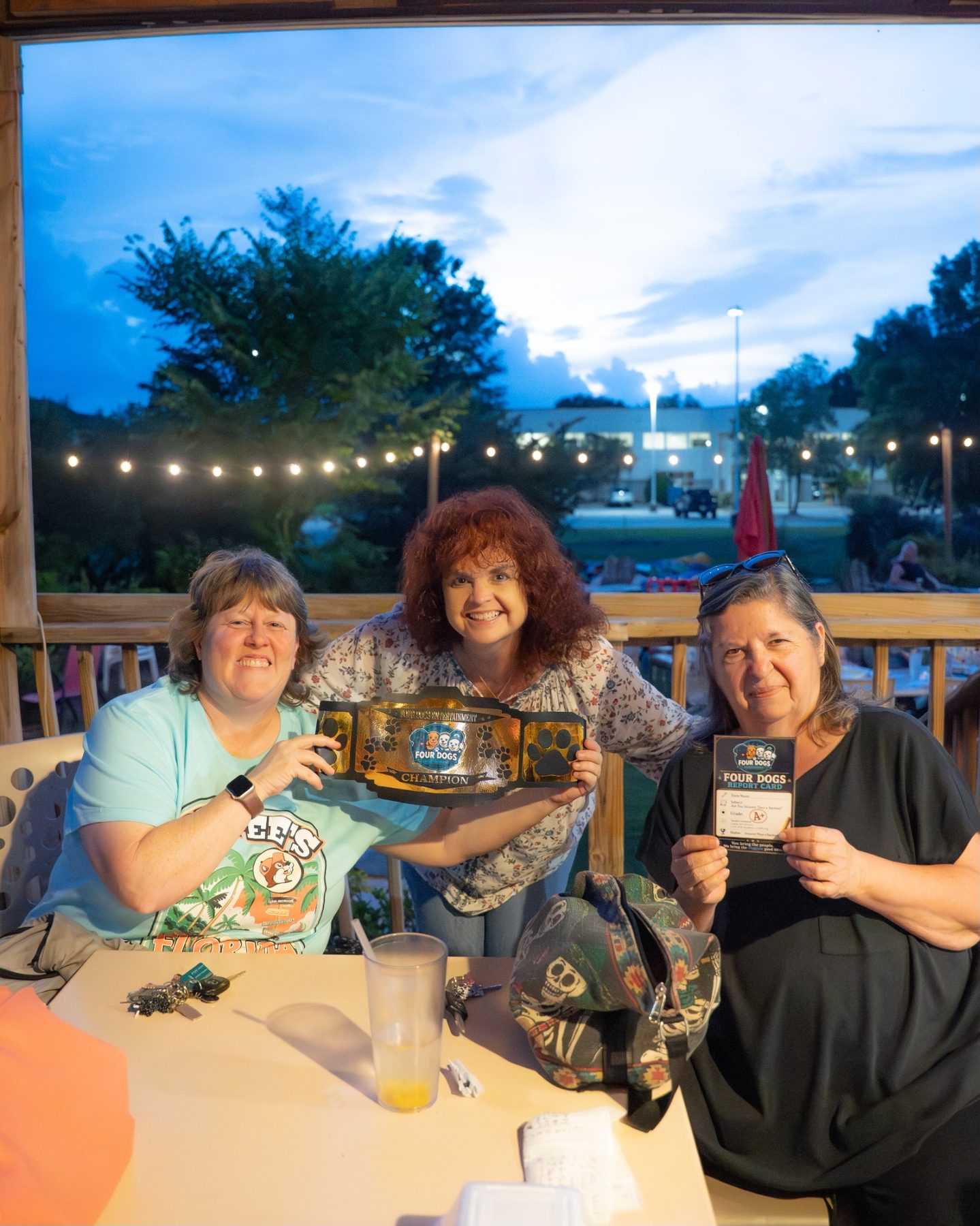 Four Dogs champions with the prize belt and report card