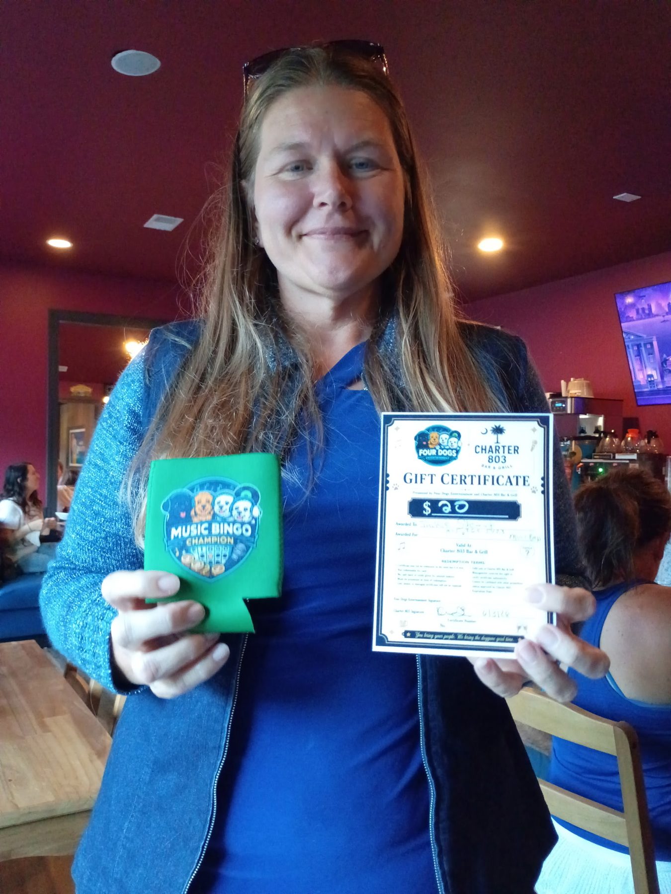 Music bingo winner with Four Dogs prize and Charter 803 gift certificate