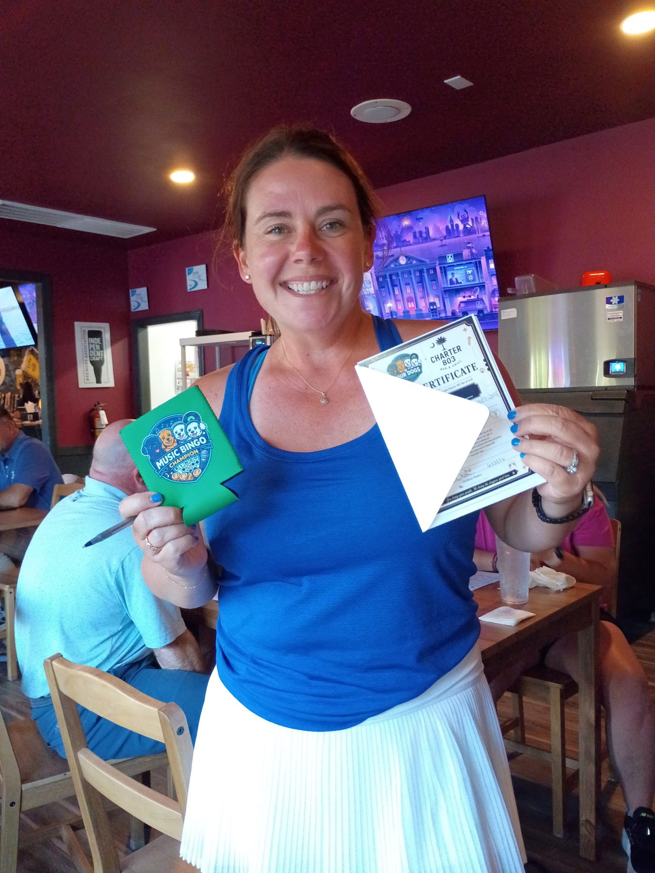 Music bingo winner with gift certificate and champion koozie