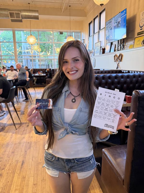 Music bingo winner holding prize at Four Dogs Entertainment event in Columbia SC