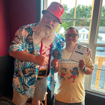 Santa Jim greeting guests at a Four Dogs holiday party