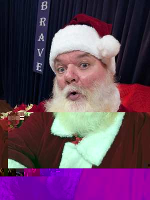 Santa Jim in a traditional red suit and real beard