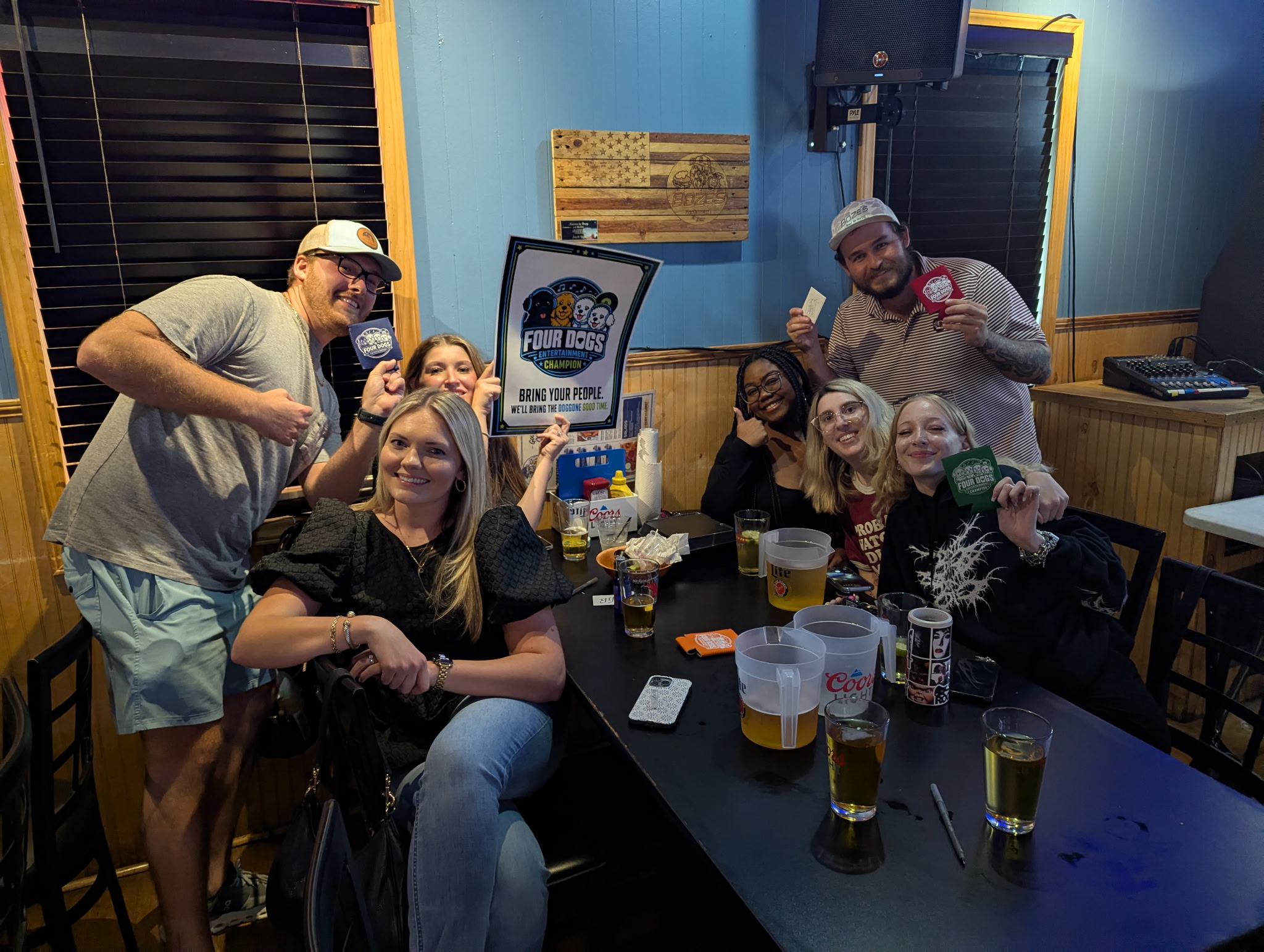 Friends gathered around a table during Four Dogs Entertainment Survey Showdown at Boze’s Restaurant & Bar